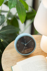 Night blue Monocle alarm clock styled on a shelf
