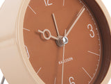 Close up of the caramel brown Monocle clock face and glass lens
