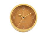 Ochre yellow Monocle alarm clock shown from an angle