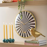 Black Candy Swirl wall clock styled on a shelf with candles