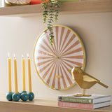 Sand brown Candy Swirl wall clock styled on a shelf with candles