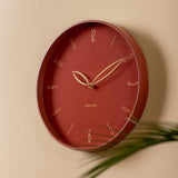 Red ochre Petals wall clock styled on a wall