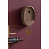 Mocha brown Tweet pendulum clock styled on a deep red wall
