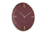 Detail of the burgundy red Riqueza clock textured dial and gold hands