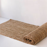 A Garcia Home Jute Runner Bubble Natural Brown 80x300cm on a white surface.