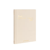 Beige notebook with gold text on a white background