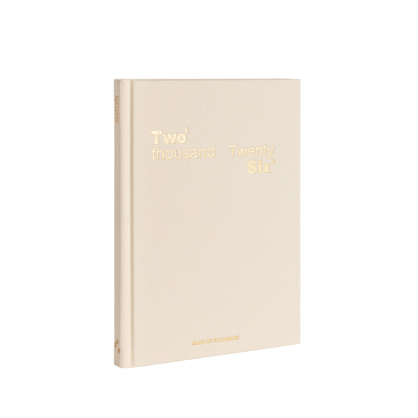 Beige notebook with gold text on a white background
