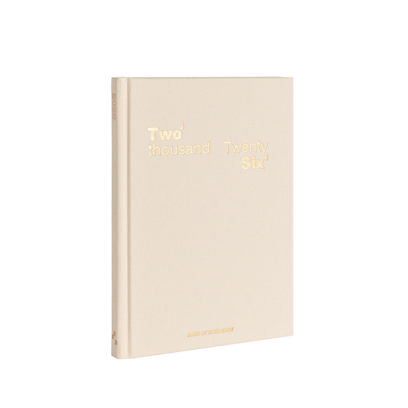 Beige notebook with gold text on a white background