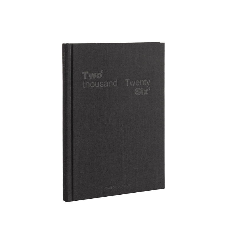 Black notebook with 'Two thousand Twenty Six' text on a white background