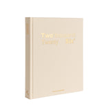 Beige notebook with 'Two thousand Twenty Six' printed in gold on a white background