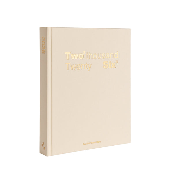 Beige notebook with 'Two thousand Twenty Six' printed in gold on a white background