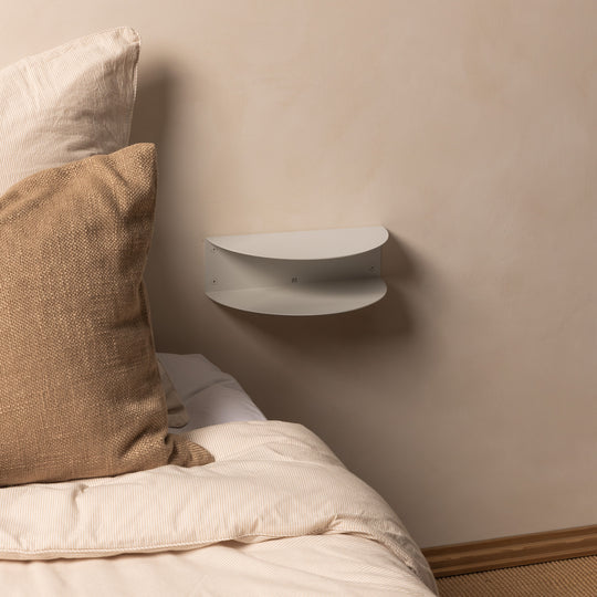 Empty white FOLD Bedside Table Mini mounted above a bed