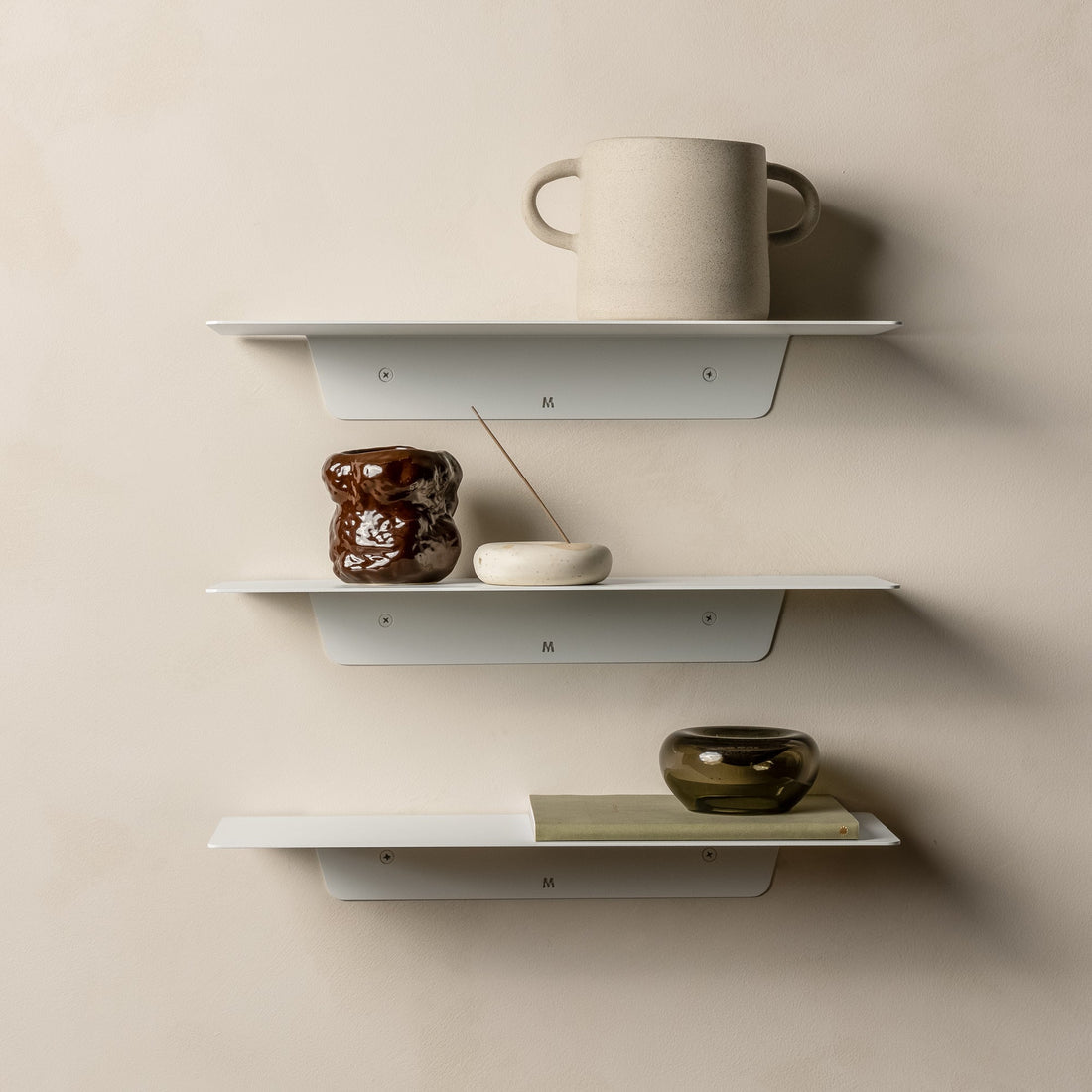Three white FOLD Ledges styled with a mug, vases and small dishes