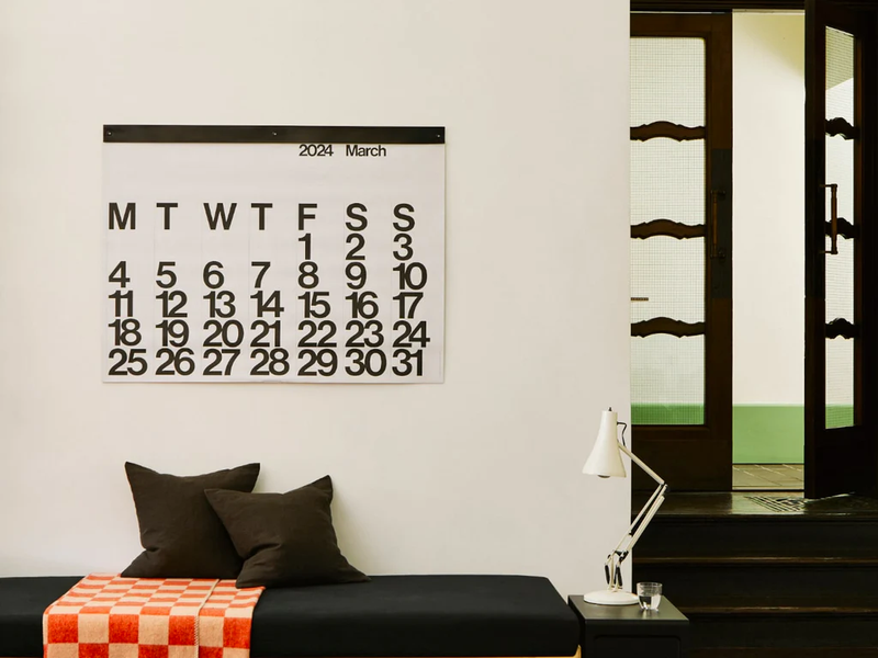 A 2024 Stendig Calendar - PREORDER, a modern graphic design, hanging on a wall.