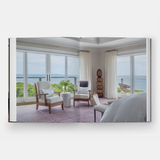 A photo of a bedroom with a view of the ocean, from the product "LANGUAGE OF HOME: THE INTERIORS OF FOLEY & COX" by brand "Books".