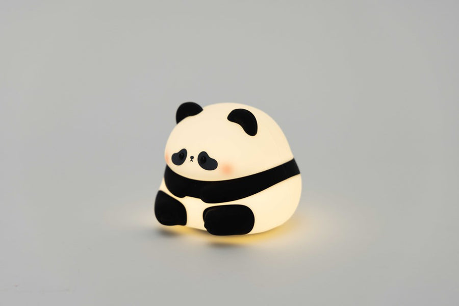 Sumo Panda Night Light glowing on a bedside table