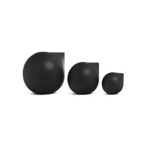 Three small black Flux Home Varese vases on a white surface.