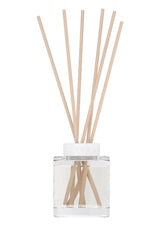 Clear diffuser bottle with wooden sticks on a white background