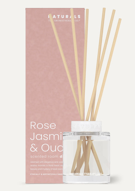 Naturals Rose Jasmine & Oud reed diffuser in front of its dusty pink box