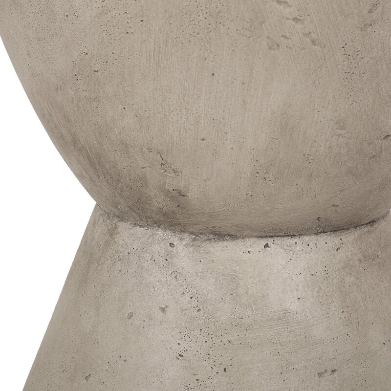 Close on the stonewash concrete waist, pitted texture across the surface