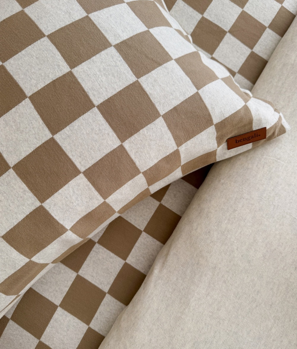 Close-up of the khaki gingham check pillowcase with the leather Bengali tab on the edge