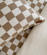 Close-up of the khaki gingham check pillowcase with the leather Bengali tab on the edge