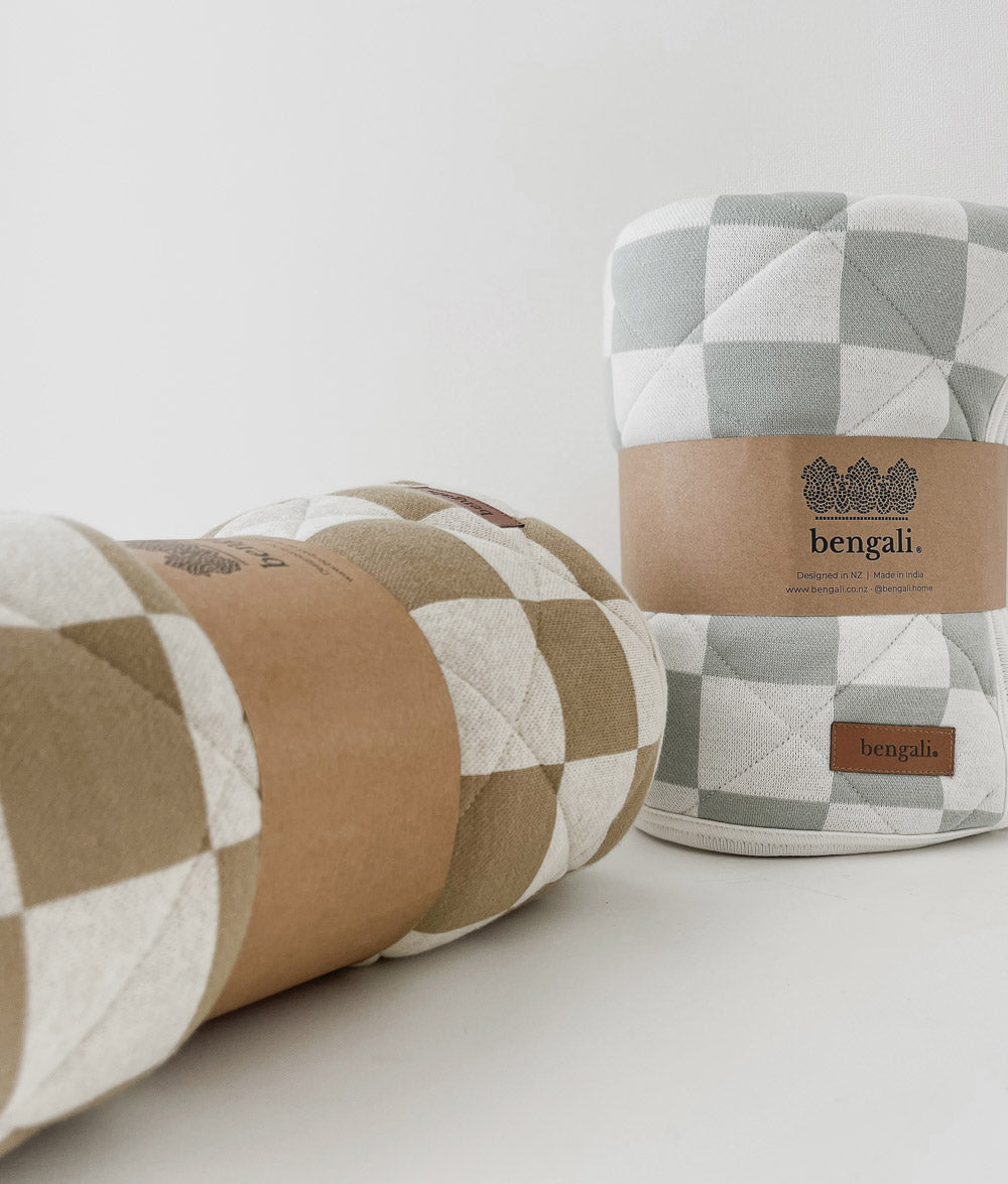 Rolled Sage Gingham and Khaki Gingham reversible quilts in their Bengali paper bands