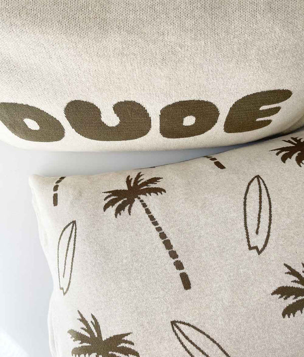 Surfing Palm kids cotton pillowcase in natural with olive palms and surfboards beneath a DUDE pillowcase