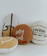 Basketball sherpa cushion grouped with surfboard and Salty Soul cushions on a white backdrop