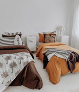 Shared kids room with two beds dressed in striped pillowcases, chocolate and tobacco bedding