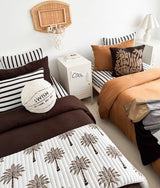 Shared kids room with two beds, the basketball sherpa cushion sitting on the chocolate bed