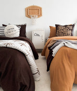 Kids room with a rattan basketball hoop and the sherpa basketball cushion on the near bed