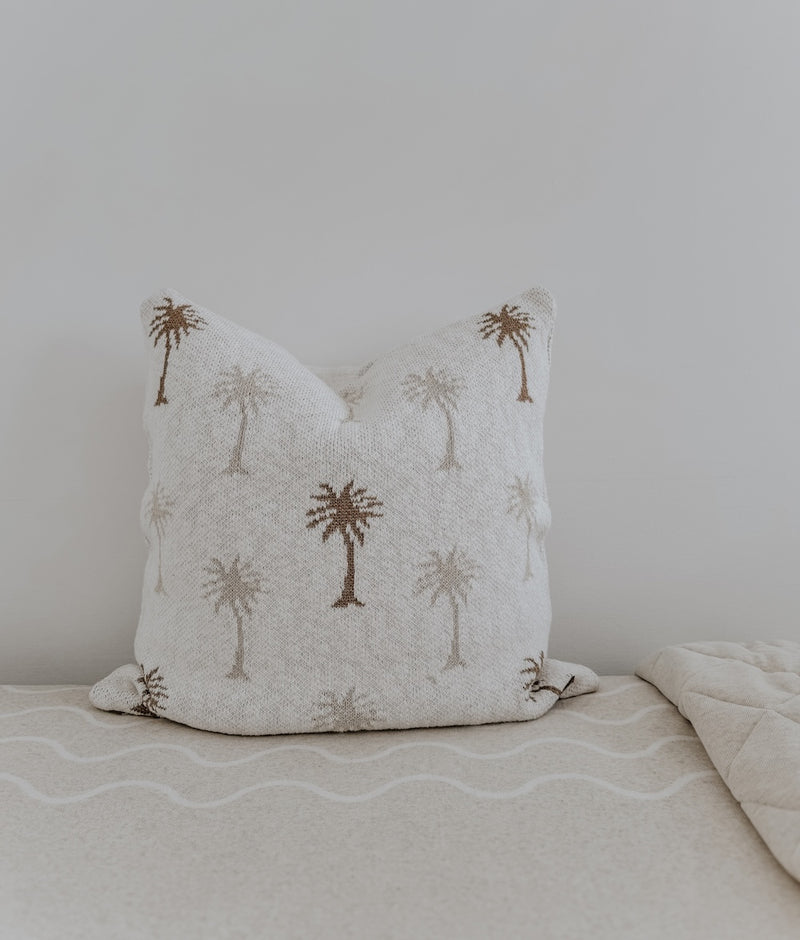 Palma palm cushion cover in ivory slub with natural and khaki palm trees, on a Coastal Marle sheet