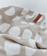 A white and beige JERSEY COTTON SHEET - MOON PHASE blanket with a label on it by Bengali Collections.