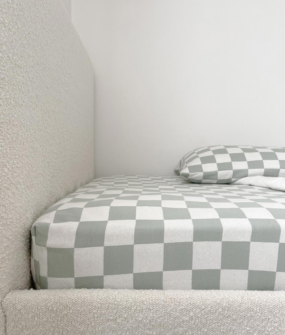 Sage Gingham jersey cotton fitted sheet on a boucle kids bed with a matching pillowcase