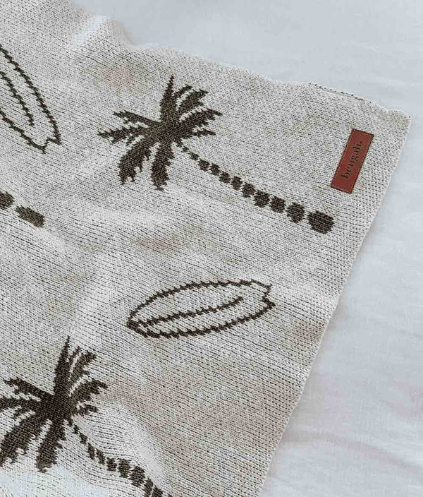 A SURFING PALM BLANKET with palm trees on it, from Bengali Collections.