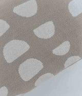 A beige JERSEY COTTON SHEET - MOON PHASE pillow with white dots on it by Bengali Collections.