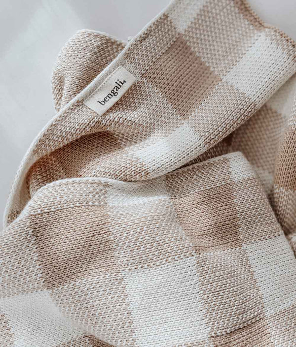 A TAN GINGHAM BABY BLANKET from Bengali Collections on a white surface.
