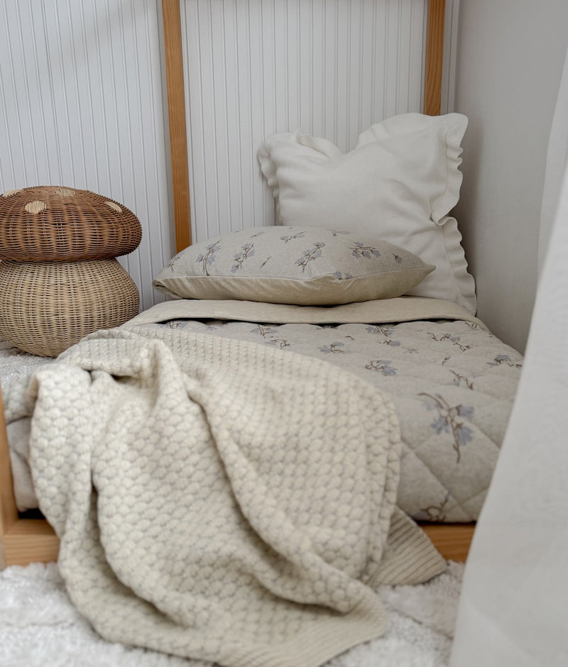 Ivory Frill euro pillowcase on a timber bed with a bluebell print pillowcase, quilt and knit throw