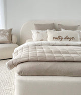 Bed styled with a salty days cushion, dune palm pillows and a quilted dune throw