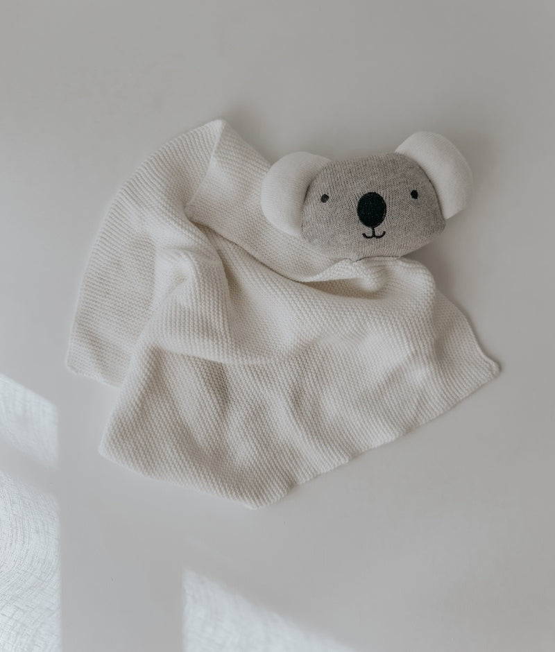 Koala baby comforter snuggly laid flat, a grey koala face on an ivory knit cuddle cloth