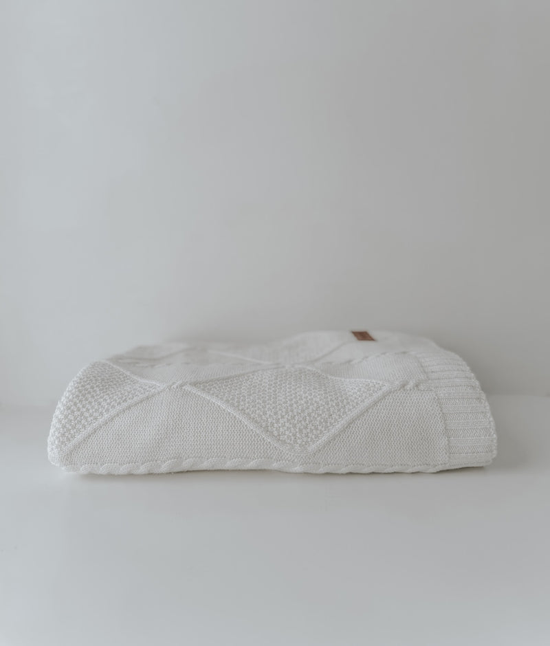 Folded Ivory Diamante knit cotton throw showing the raised diamond pattern on a white backdrop