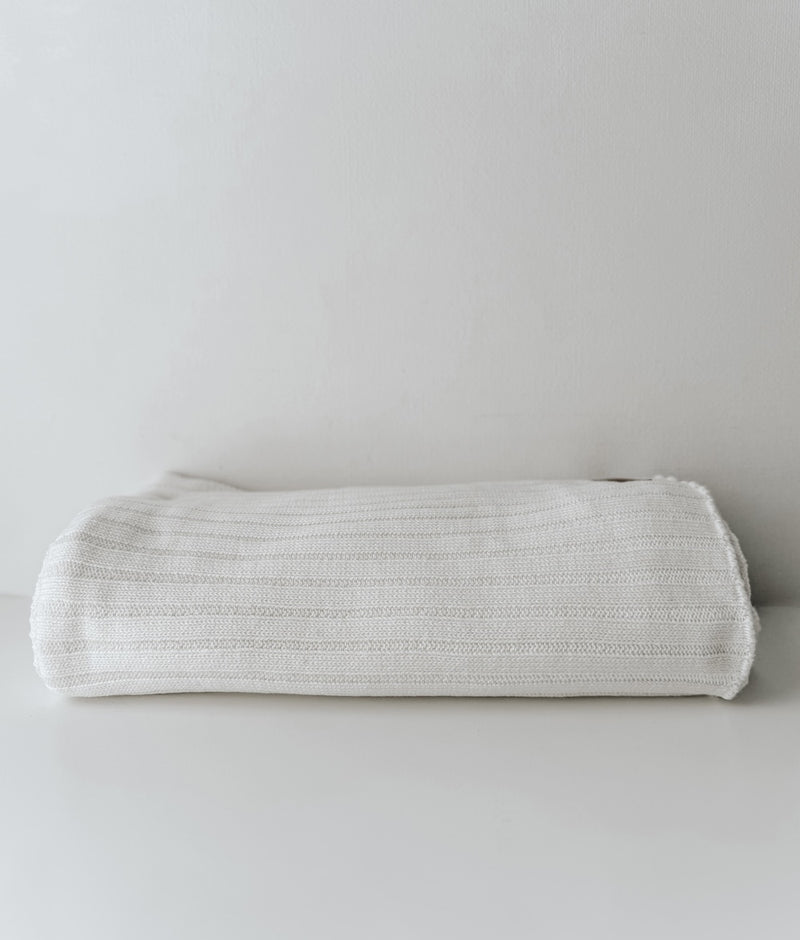 Folded Ivory Corduroy knit cotton lounge throw with fine ribbed texture on a white backdrop