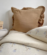Khaki frill euro pillowcase against an ivory headboard with floral bedding in front