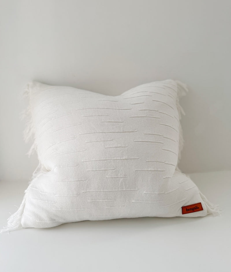 Ivory Flurry textured cotton cushion cover with fringed edges on a white backdrop