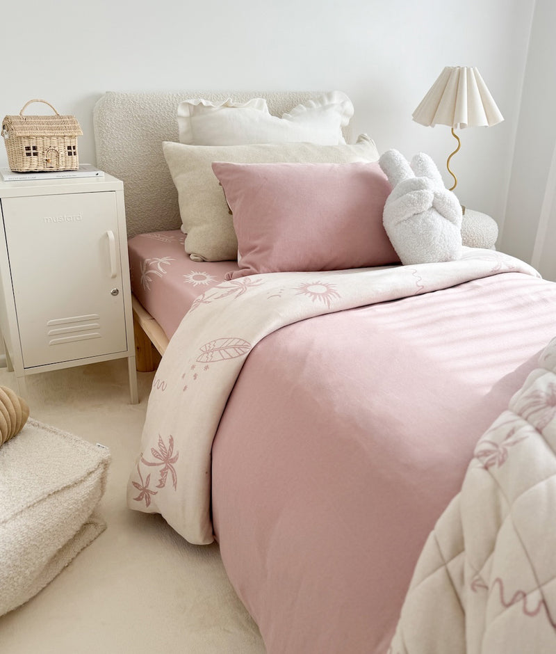 Kids bed in blush and ivory bedding with Ivory Frill euro pillowcases, a Peace Sherpa cushion and pleated lamp