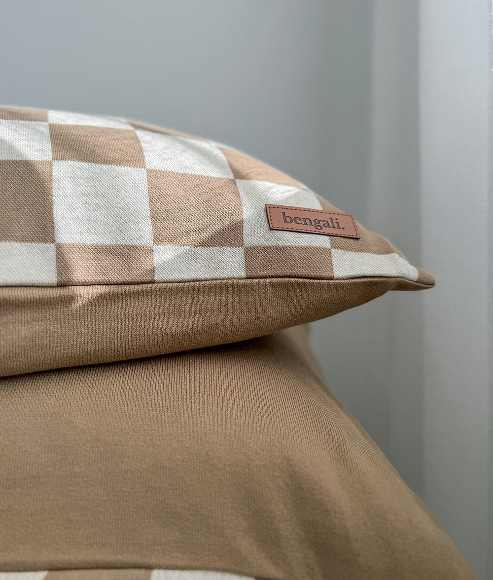 Close-up of the khaki gingham euro pillowcase showing the leather Bengali tab on its edge
