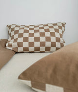 Khaki gingham check pillowcase lying flat on a bed beside a plain khaki pillow