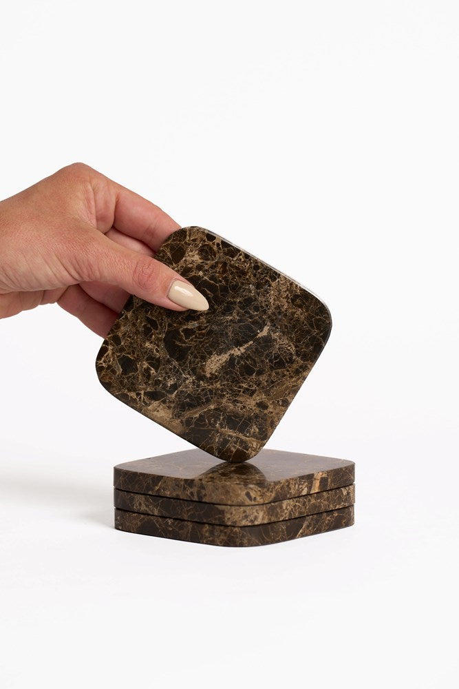 Stack of natural stone coasters styled on a side table
