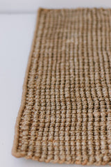 A Garcia Home Jute Rug Bubble Natural Brown hand woven on a white surface.